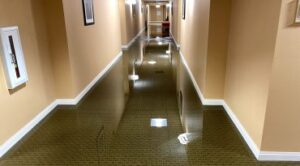 A flooded apartment building hallway