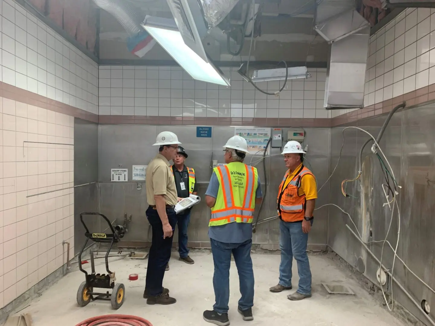 A group of workers repairing a production room